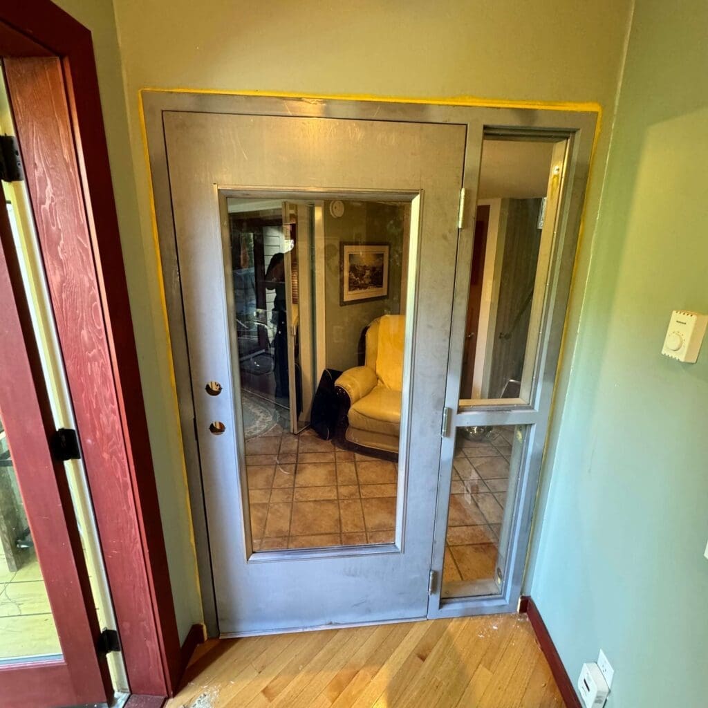 A double glass door leading to a room